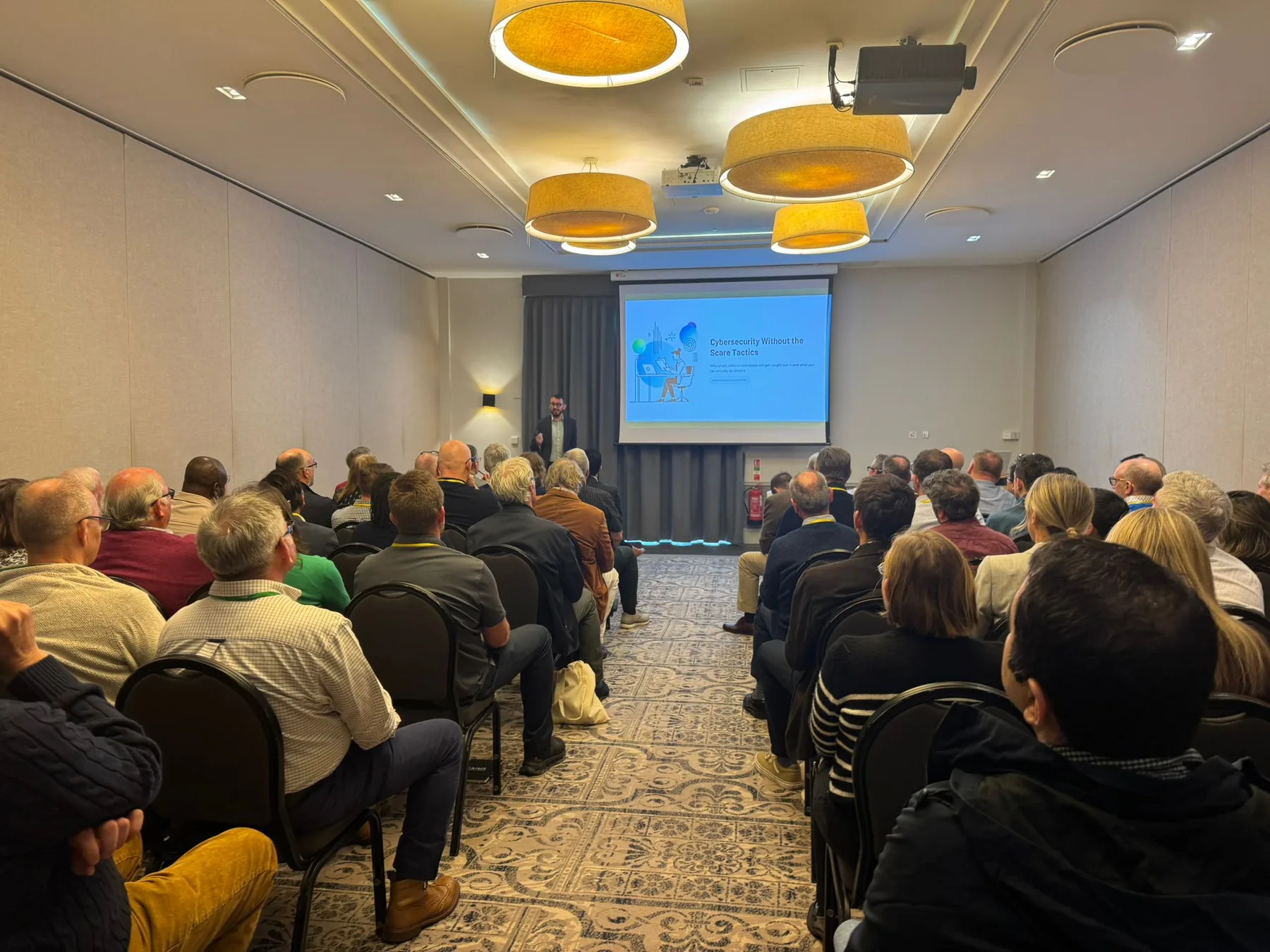 Tom presenting Cybersecurity Without the Scare Tactics to a conference audience